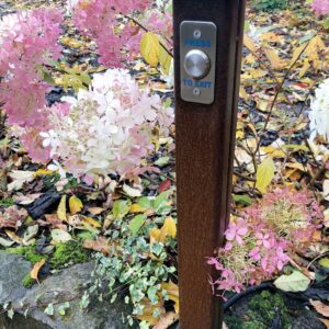 Panelled COR-TEN driveway entrance gates exit button