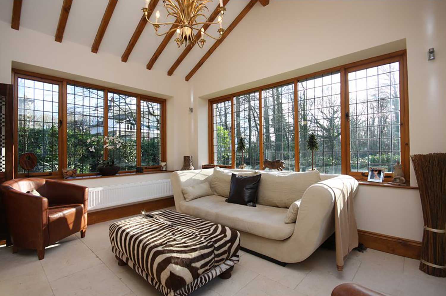 Garden room with beams, feature light, seating and leaded windows