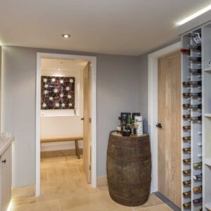 Bespoke wine rack and gin rack with a whisky barrel in the corner