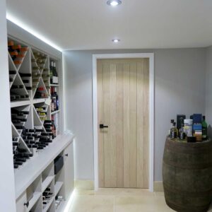 Bespoke wine rack and gin rack, stone flooring and a whisky barrel in the corner