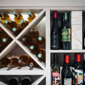 Close up of wine bottles in a bespoke wine rack and gin rack