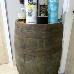 Whisky bottles sitting on a whisky barrel
