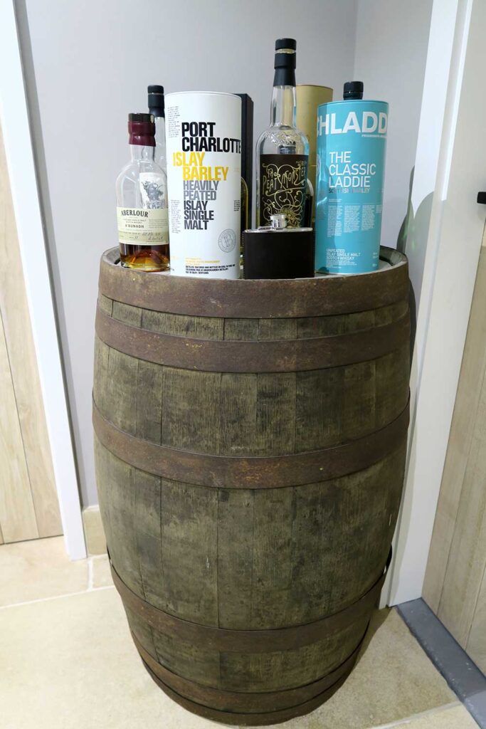 Whisky bottles sitting on a whisky barrel