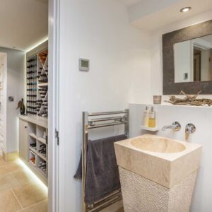 Small bathroom with sink, towel radiator and slate mirror