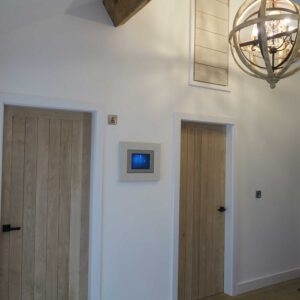 Entrance hall with wood flooring, wood bedroom doors and feature lighting