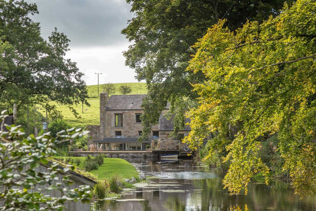 Exterior view of the mill pond and the mill as part of a grade II Mill Renovation