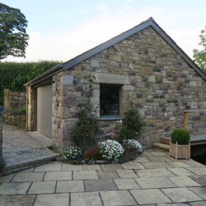 Side view of a tone garage and joining patio