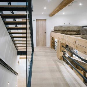 Bespoke commission of a three flights staircase with a juxtaposition of materials using a metal frame, wood treads and glass panelling. Bespoke lighting and matching metal handrail.