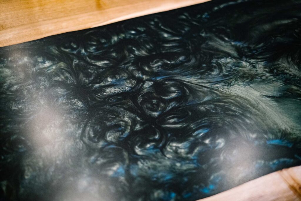 Close up of combining resin and wild walnut, this dining table really enhances the beauty of nature by adding an artistic modern twist and delivering striking craftsmanship perfection. Designed by Charlotte Findlater Design, an award winning interior design studio specialising in luxury, high-end residential & commercial projects that respect time, nature and people.