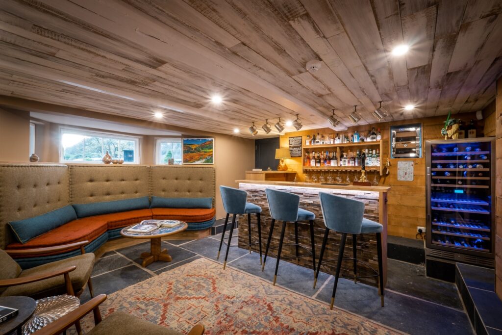 Bespoke banquette seating, cabinetry and lighting as part of a bar renovation