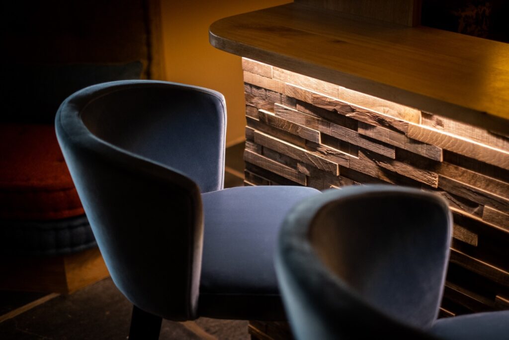 Close up on bar stools in a bar renovation designed by Charlotte Findlater Design, an award winning interior design studio specialising in luxury, high-end residential & commercial projects that respect time, nature and people.