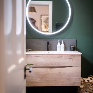 Close up of an illuminated ensuite vanity mirror