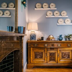 Dining room renovation with rich deep colours, handmade furniture and antique sea creature designed plates on the wall