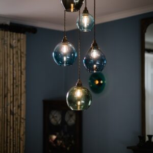 Close up of bespoke glass pendant lights in a dining room