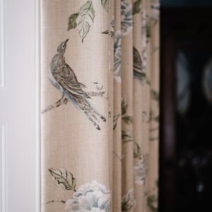 Close up of bird and flower curtains in a dining room
