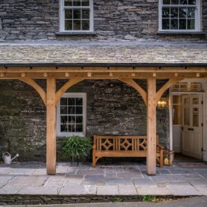 Bespoke Oak Portico and bench on the front Lake District home