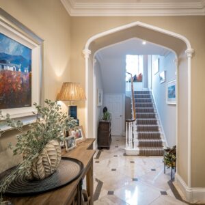 Calmly and light reflecting styled entrance hallway with natural fabric stair runners in view