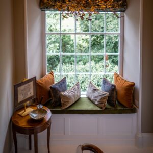 Handcrafted window seating with colourful cushions with a view outside