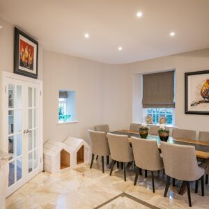 Dining area with seating for 8 in a well lit kitchen diner area
