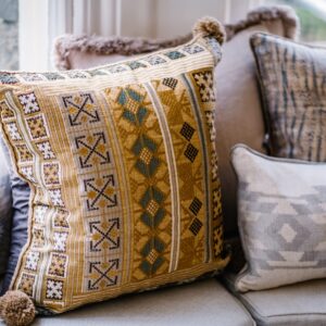 Close up of lounge seating cushions in a gold and blue pattern