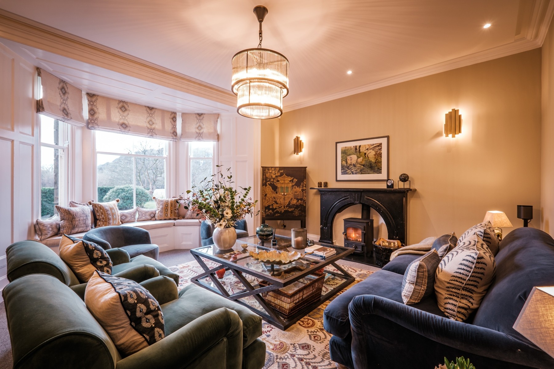 Lounge renovation to maximise social interaction in comfortable sofas, large coffee table, a fireplace and lots of natural light and a view outside
