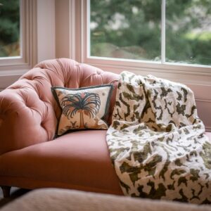Close up of a pink chaise longue in a master bedroom