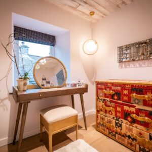 Dressing room with artisan drawers and make up seating area with a view outside
