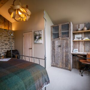 Bedroom with oak bent pendant light, bespoke wardrobe and work area