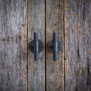 Close up of bespoke cabinetry reclaimed wood doors with juxtaposition metal handles