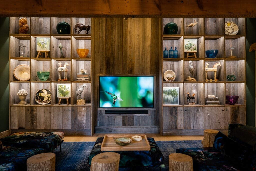 A cinema room with bespoke built ins and a large tv