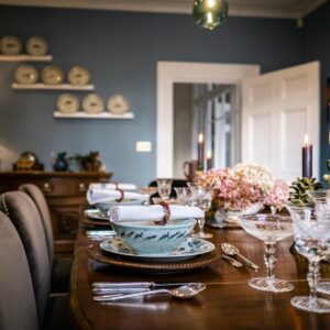 Dining room renovation with rich deep colours, handmade furniture, formally set