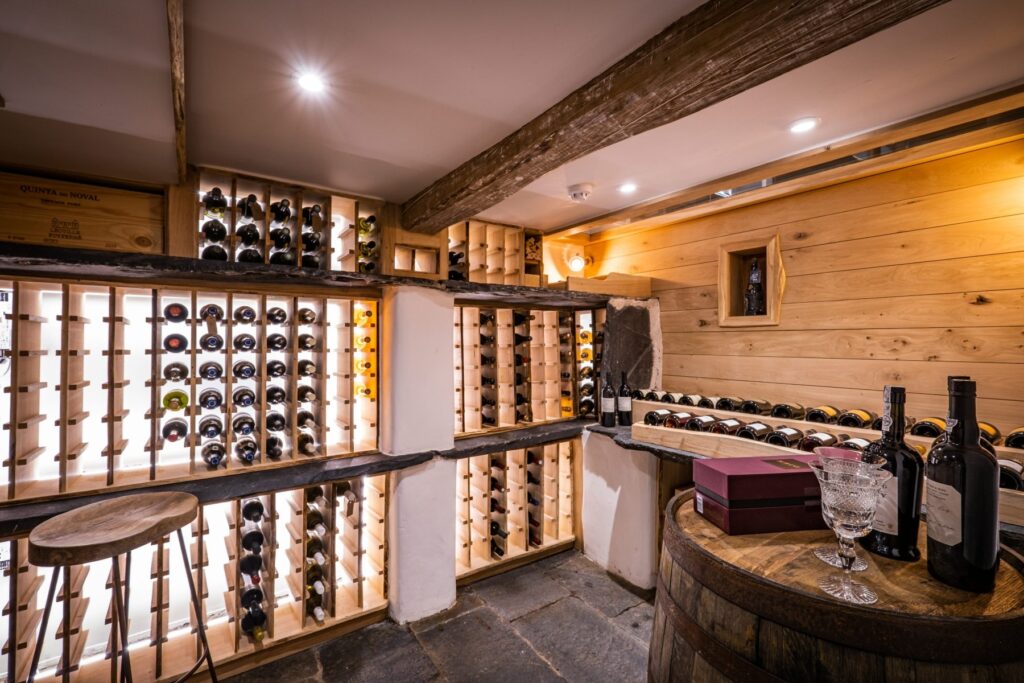 Bespoke wine cellar with oak panelling, whisky barrel and led lighting