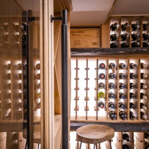 View through the bespoke glass door to a bespoke wine cellar
