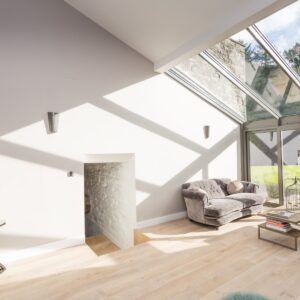 Lounge conservatory design with wood flooring and flooded with natural light