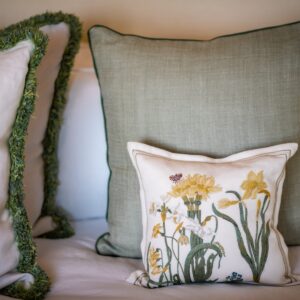 Beautiful spring green cushions and one white cushion with decorative daffodil stitching