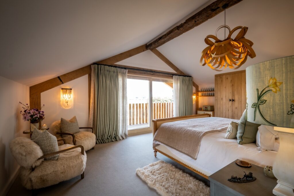 Nature and Spring design inspired master bedroom with natural carpet, bespoke cabinetry, handmade applique lamps and balcony in this divinely serene master bedroom designed by Charlotte Findlater Design, an award winning interior design studio specialising in luxury, high-end residential & commercial projects that respect time, nature and people.