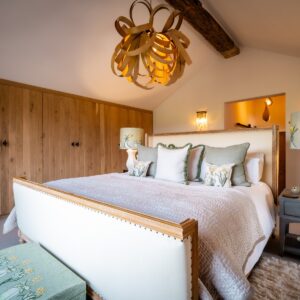Nature and Spring design inspired master bedroom with emperor bed, bespoke cabinetry, handmade applique lamps and oak bent pendant light