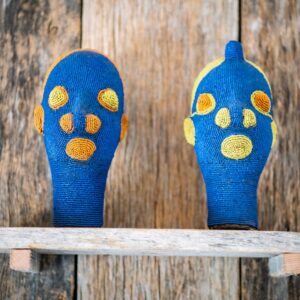 Close up of African beaded tribal heads, male and female