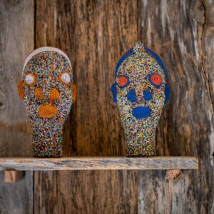 Close up of African beaded tribal heads, male and female