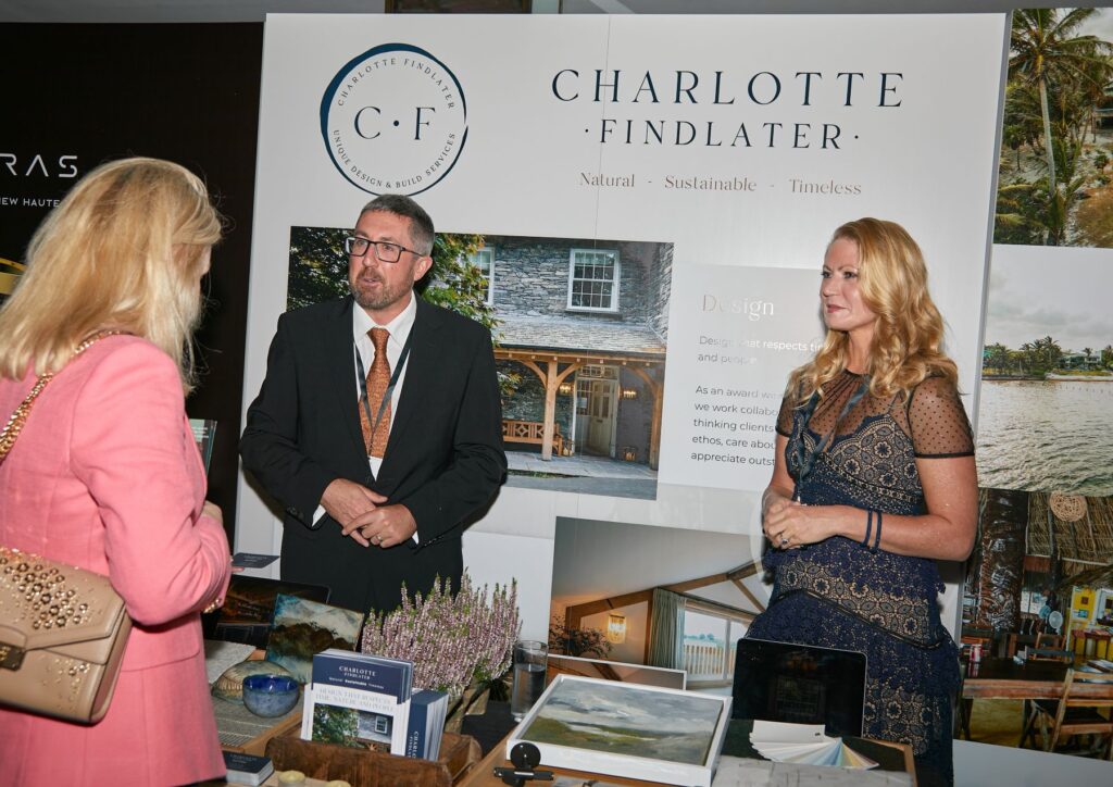 Charlotte Findlater and Scott Findlater talking with a Rolls Royce car club member about sustainable architecture, build and interior design.