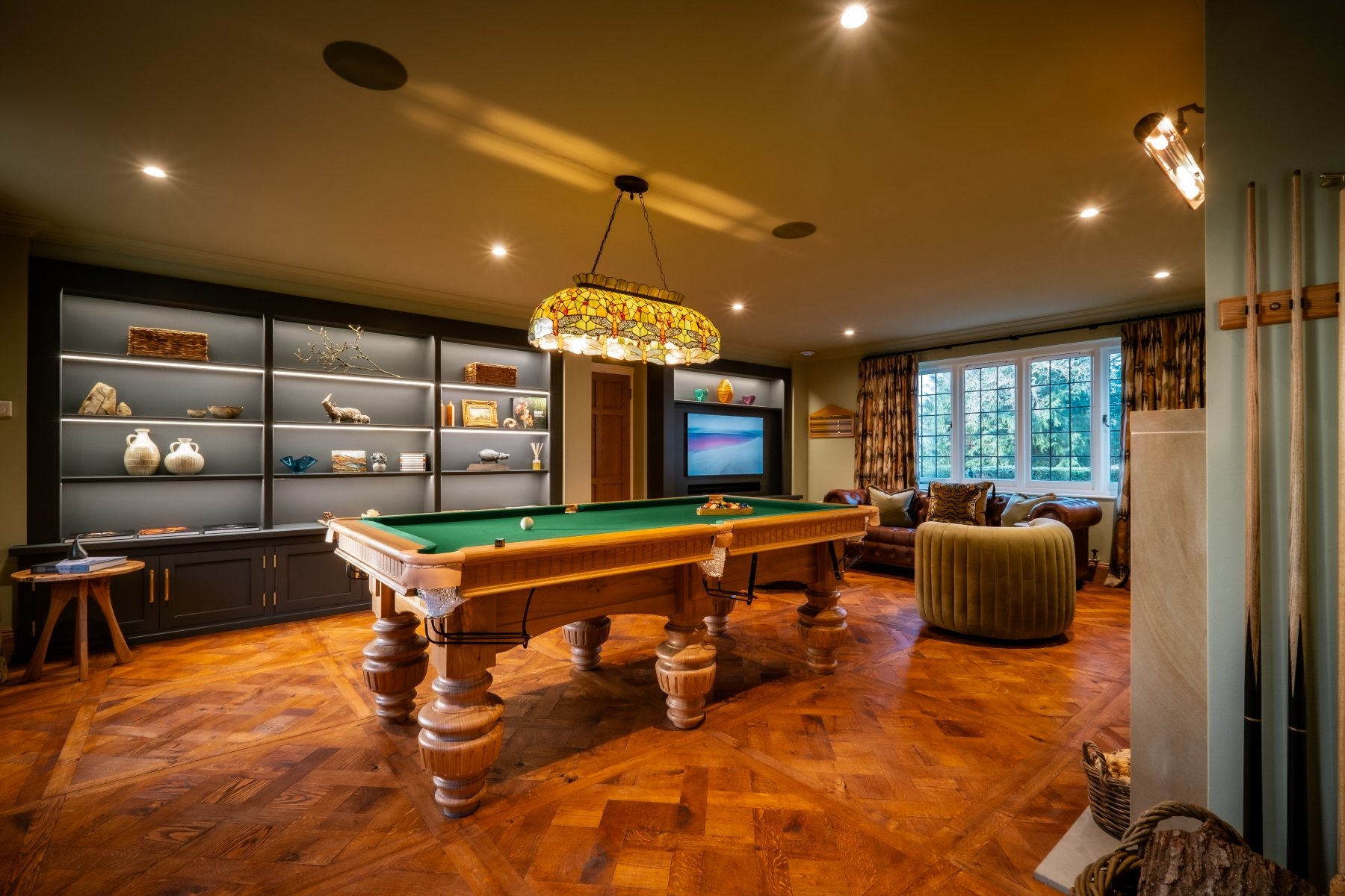 Luxury games room with bespoke Oak pool table, built ins and parquet flooring