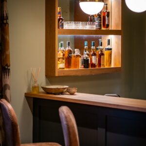 Luxury games room bar area with bar stools