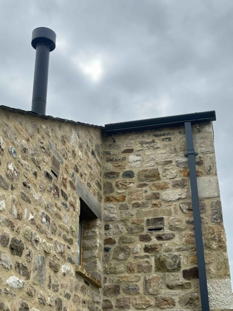 Bat boxes integrated into stone faced building