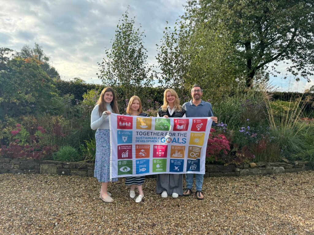The Charlotte Findlater Design Team holding the UN SDG Flag