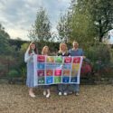 The Charlotte Findlater Design Team holding the UN SDG Flag