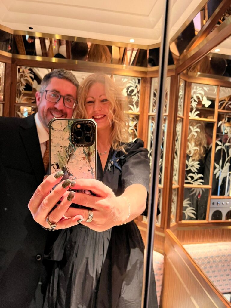 Charlotte Findlater and Scott Findlater in the lift at His Majesty King Charles III at 75: The Leadership and Vision of King Charles III, at Claridge’s in central London on His Majesty’s 75th birthday.
