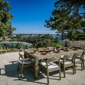 An outdoor dining area set for 10 people on the outside terrace of a Menorcan villa