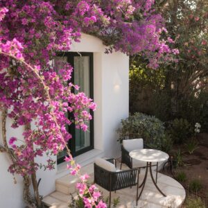 An intimate 2 chair and table set hidden in the garden of a Menorcan villa