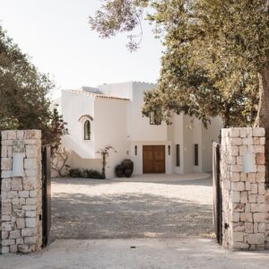 A view through the stone pillared entrance at Menorcan villa with large pots by the hand made front door