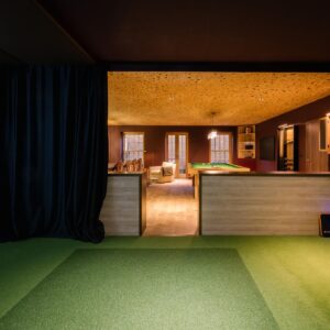 The view of the golf simulator within a luxury games room.